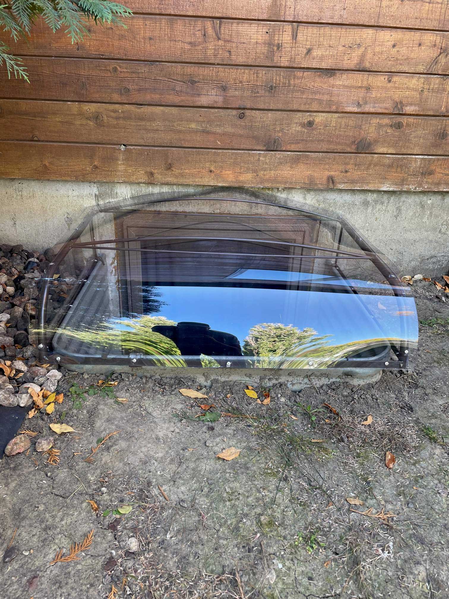 Transparent cover over basement window well