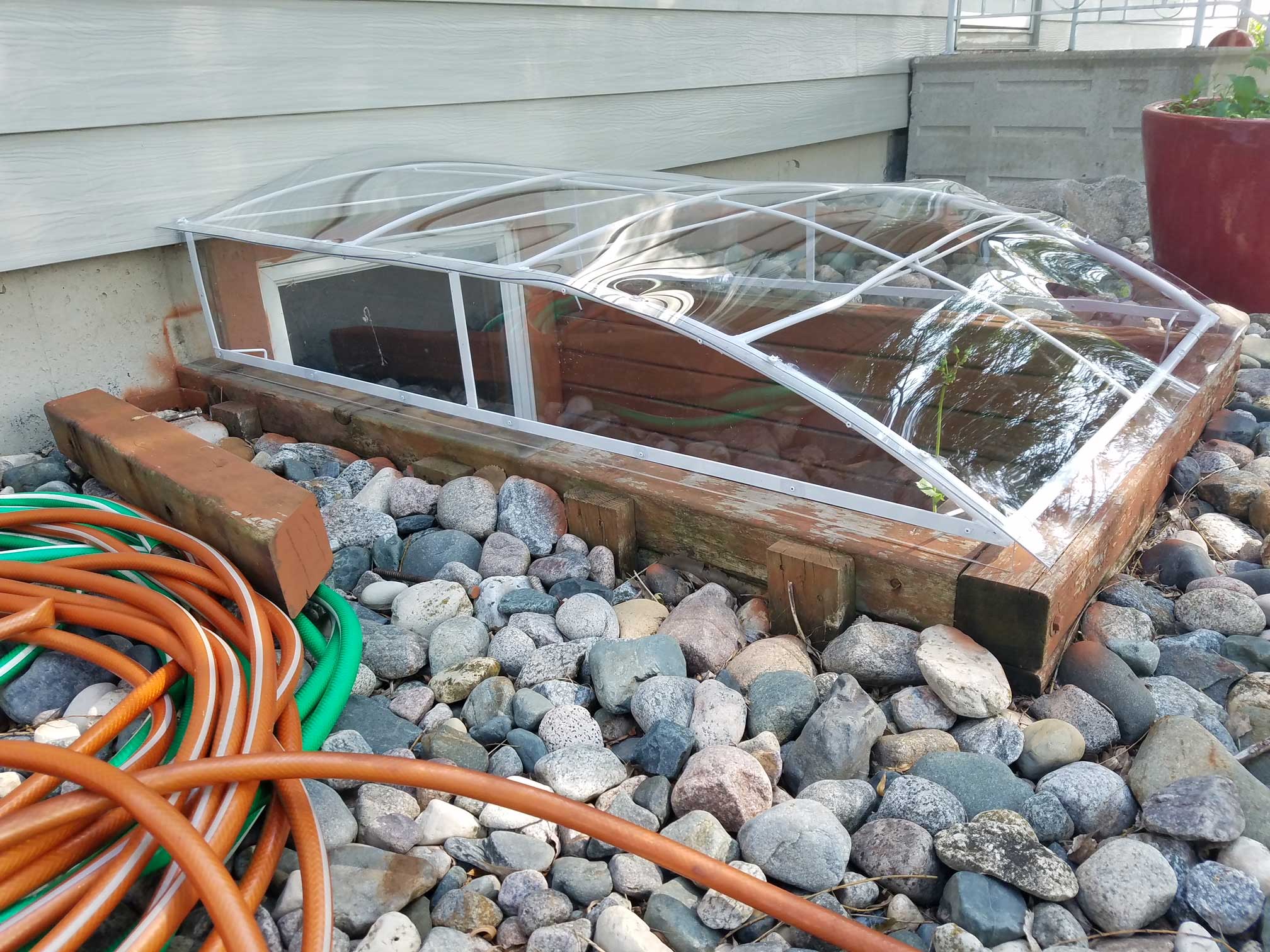 Clear arched basement window well cover