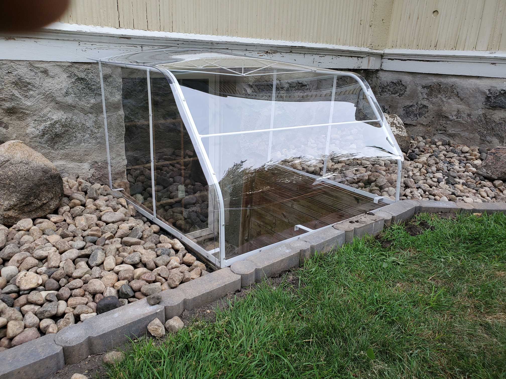 Clear plastic basement window well cover