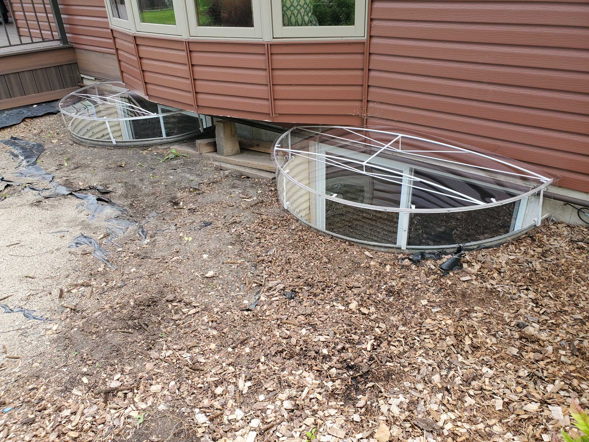 Basement window wells with metal grates