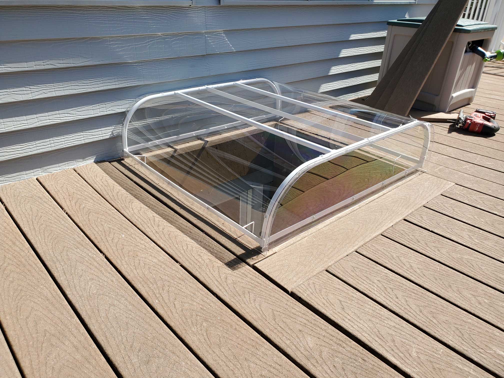 Transparent dome window well cover on deck