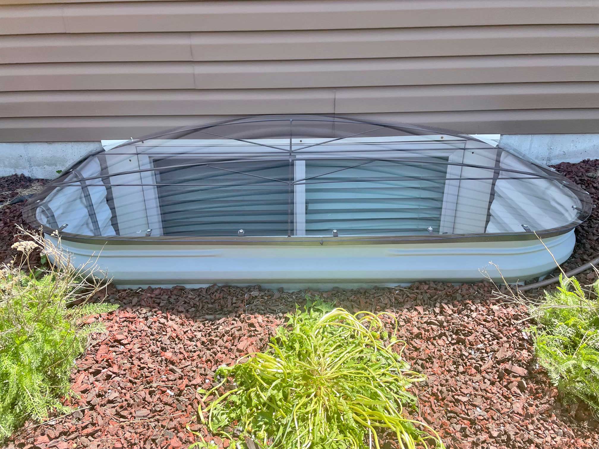Clear window well cover over basement window