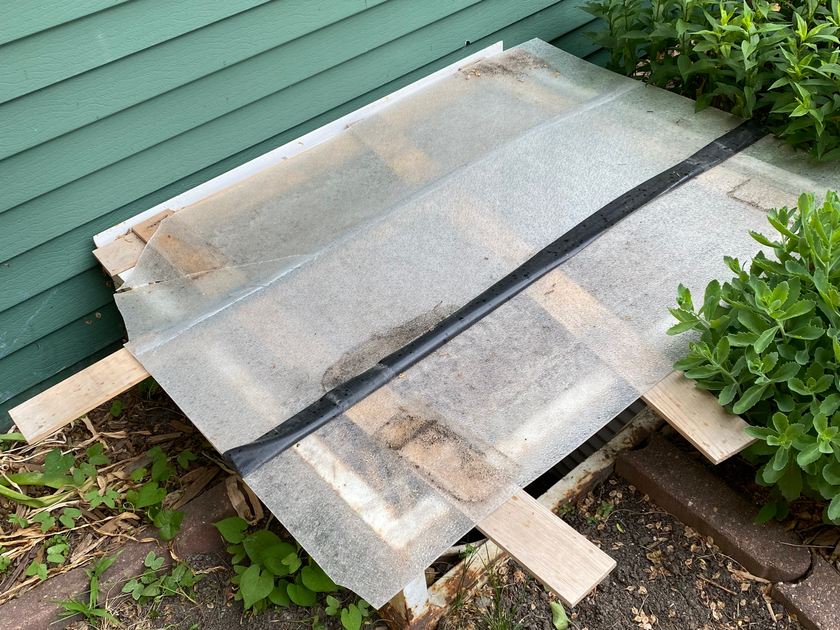 Translucent corrugated roofing panels stacked outdoors